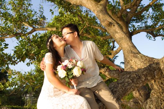 Outdoor Bride and groom on the beach in the evening.