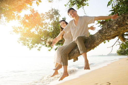 Outdoor Bride and groom on the beach in the evening.