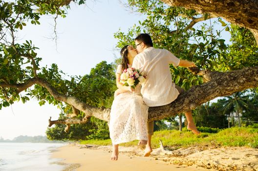 Outdoor Bride and groom on the beach in the evening.