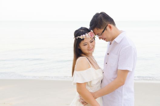 Outdoor Bride and groom on the beach in the evening.