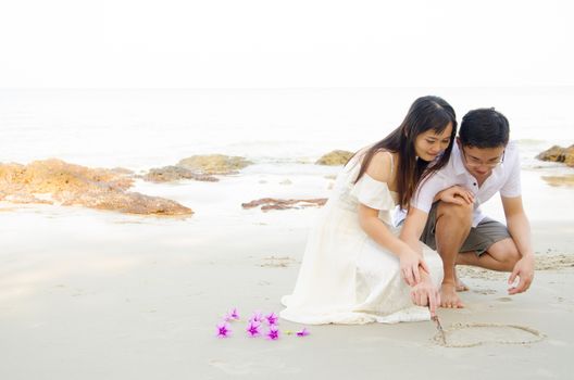 Outdoor Bride and groom on the beach in the evening.