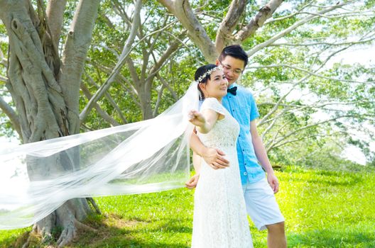 The asian couple embracing in the park