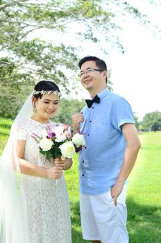 The asian couple embracing in the park