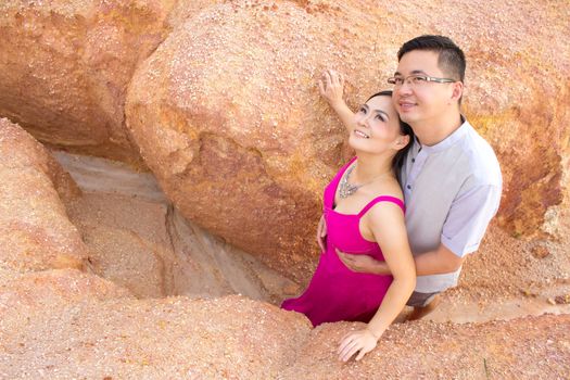 Asian couple hugging with canyon background. Valentine's day concept