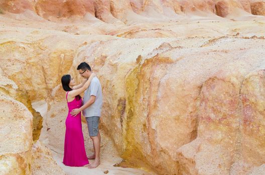 Asian couple hugging with canyon background. Valentine's day concept
