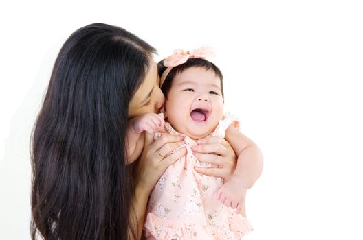 Asian mother playing with baby girl