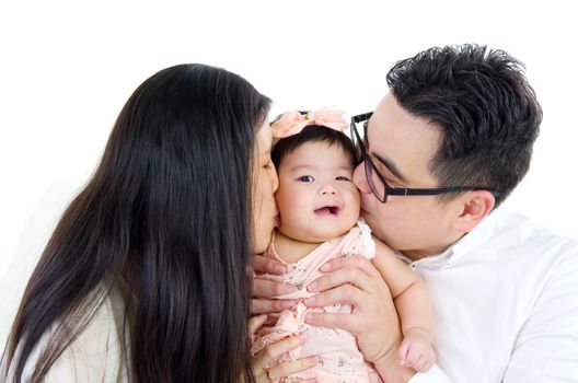 asian parent kissing their baby girl