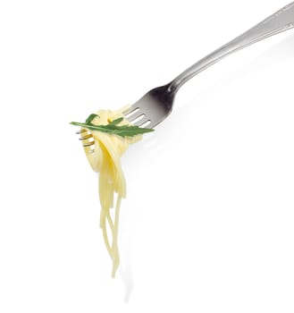 Cooked long thin cylindrical pasta and small arugula twig on the stainless steel fork closeup on a light background
