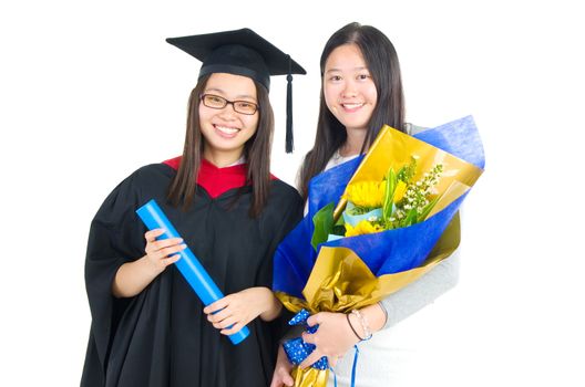 Asian university student and sister celebrating graduation