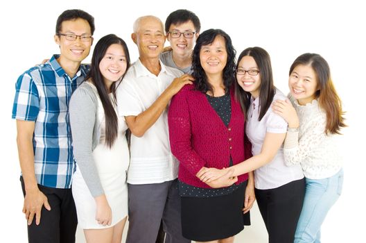 Indoor portrait of beautiful asian family over white background