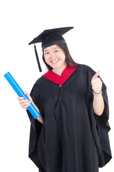 Happy university student in graduation gown and cap. Portrait of east Asian female model standing on plain background.