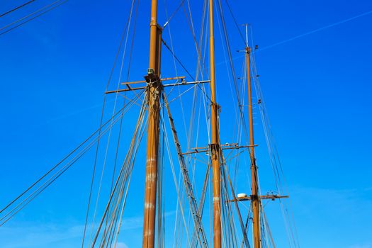 Yacht mast against blue summer sky