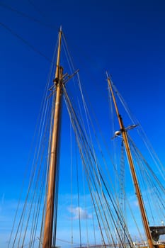 Yacht mast against blue summer sky