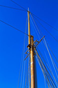 Yacht mast against blue summer sky