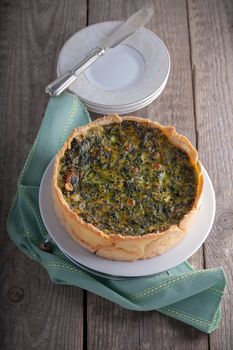 Mini Spinach Quiche with a knife served on a white plate