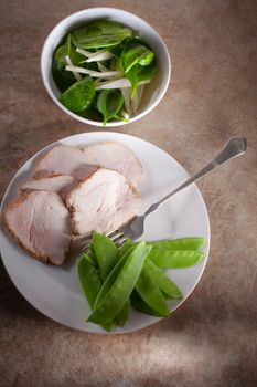 Slices of turkey breast fillet with green salad 