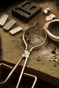 A still-life image detailing the area where some precious metals have been refined and casted into some ingot bars.