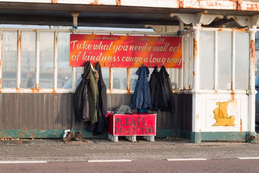 Seaside shelter on Hove promenade, with donated clothes free for homeless people to take.