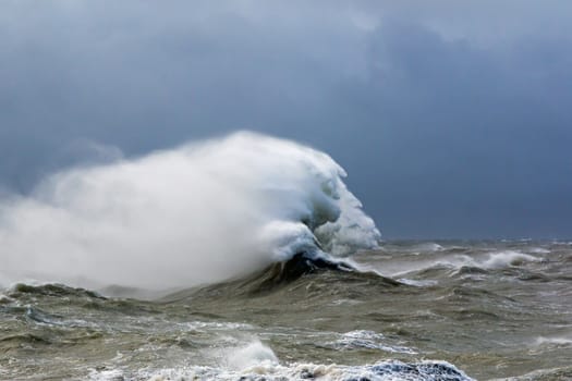 High tide at Newhaven, East Sussex, during Storm Doris in February 2017. Waves in rough sea forming face-like appearance in the strong wind.