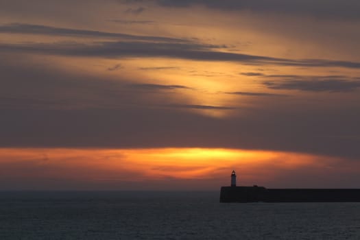 Sunset sky and clouds over Newhaven Lighthouse, East Sussex.