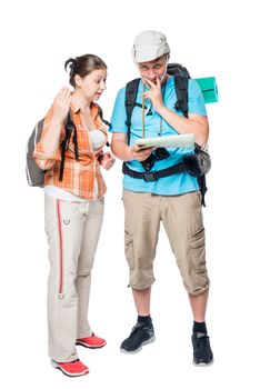 Couple of tourists arguing and looking for a path on a map on a white background in the studio