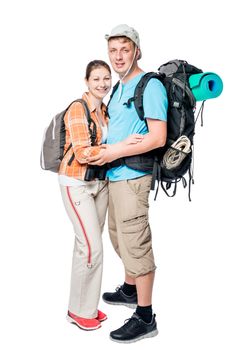 Smiling couple of tourists with backpacks in studio on white background