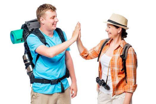 Successful and active tourists with backpacks, happy couple on a white background