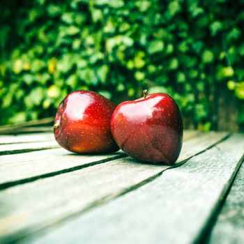 fresh red apple on wooden table