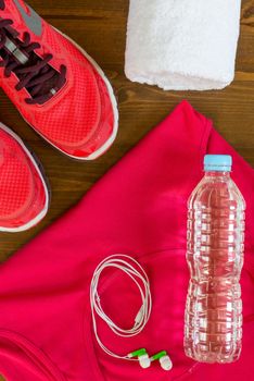 shoes, water bottle and towel on the wooden floor of sports