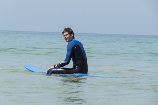 Young boy surfing in the sea