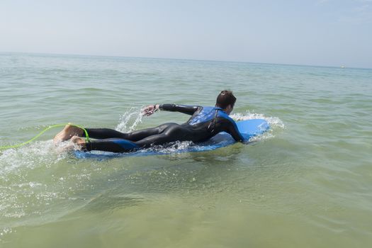 Young boy surfing in the sea