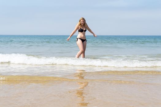 Beautiful young girl enjoying the beach in summer
