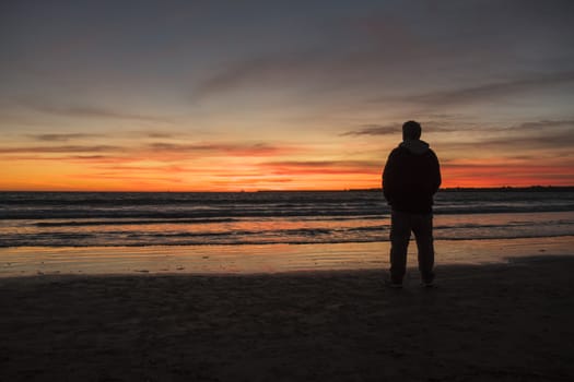 Silhouette of man on a beautiful sunset on the beach