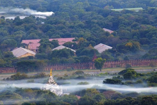 Mandalay with lake mountains, temples and pagodas seen from mandalay hill at sunset, Burma.