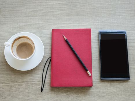 A cup of coffee with notebook and tablet on table, time for creative idea