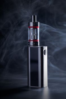 Electronic cigarette close-up on a black background in smoke