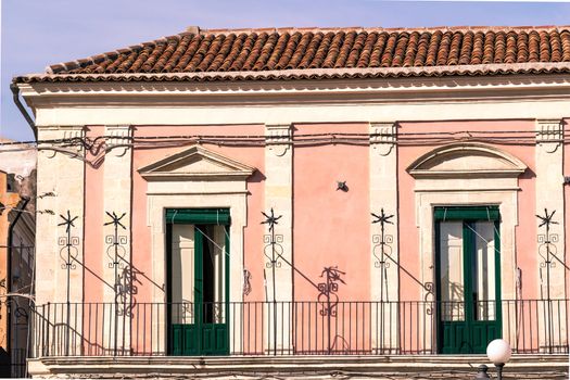 green door of an old Sicilian pink house