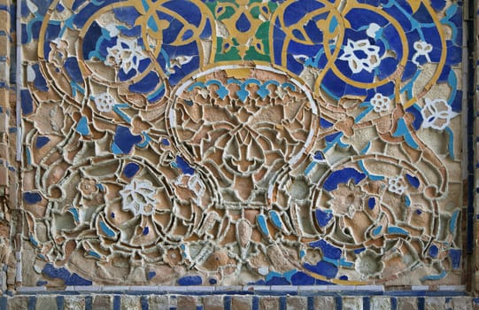 Piece of the old mosaic on the wall of an ancient building of Registan square, Samarkand, Uzbekistan