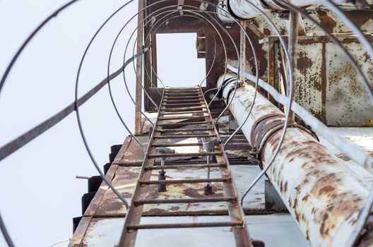 Rusty ladder on an abandoned building site