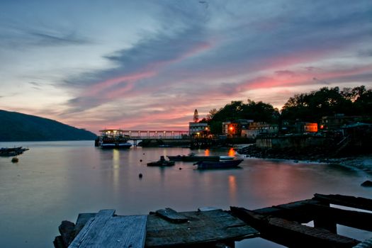 Sunset with beach, boats and ship port