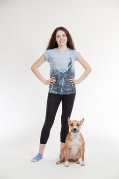 the young beautiful girl and her dog on a white background