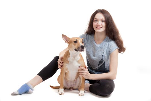the young beautiful girl embraces a dog