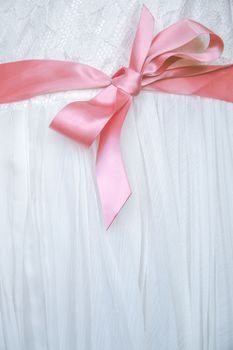 Detail Of A Pink Bow On The White Lace Dress Of A Flower Girl At A Wedding