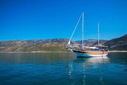 yacht on bay and castle in Kekova, near ruins of the ancient city on the Kekova island, Turkey