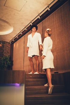 Beautiful young couple enjoying at the spa centre.