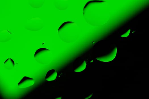 Abstract Background with Oil Drops on Black - Green
