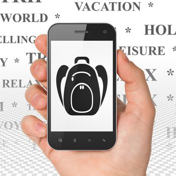 Tourism concept: Hand Holding Smartphone with  black Backpack icon on display,  Tag Cloud background, 3D rendering