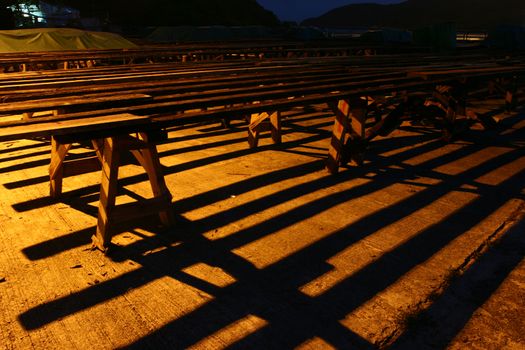 Wooden block under sunset with shadow