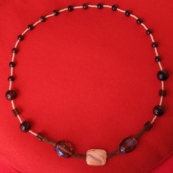 Necklace made of semi precious gems on red background