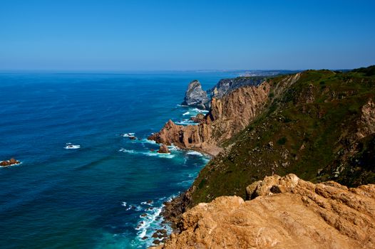 Impressive Landscape with Stormy Ocean and High Sheer Cliffs over Horizon in Sunny Day Outdoors. Cabo da Roca, Portugal 